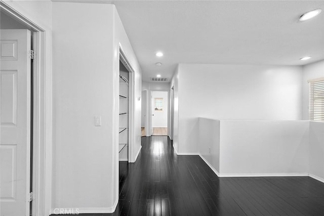 14271 Blackstone St, Hesperia, CA 92345 - hallway with baseboards, dark wood-style floors, and recessed lighting