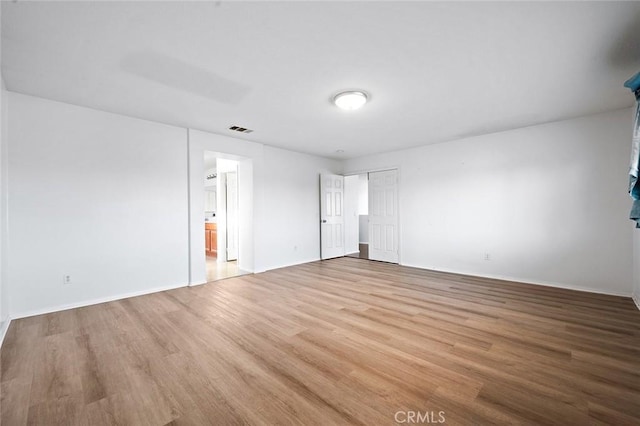 14271 Blackstone St, Hesperia, CA 92345 - unfurnished bedroom with wood finished floors, baseboards, and ensuite bath