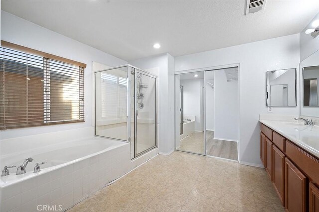 14271 Blackstone St, Hesperia, CA 92345 - full bath featuring a shower stall, a bath, vanity, recessed lighting, and baseboards