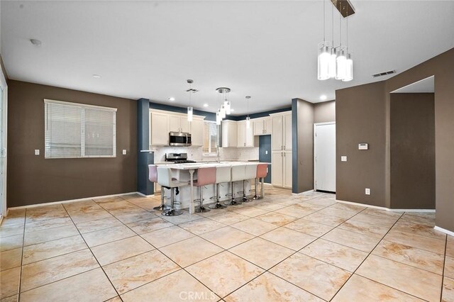 14271 Blackstone St, Hesperia, CA 92345 - kitchen with stainless steel appliances, light countertops, light tile patterned floors, white cabinetry, and recessed lighting