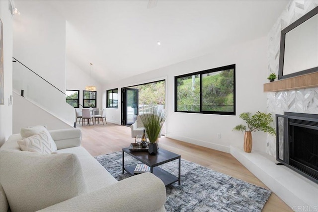 2464 Haller St, San Diego, CA 92104 - living room featuring baseboards, light wood-style floors, a fireplace, high vaulted ceiling, and stairway