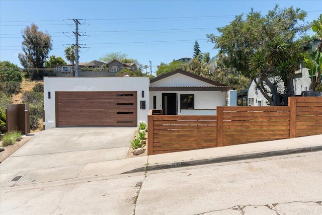 2464 Haller St, San Diego, CA 92104 - view of front of home featuring stucco siding, driveway, and an attached garage
