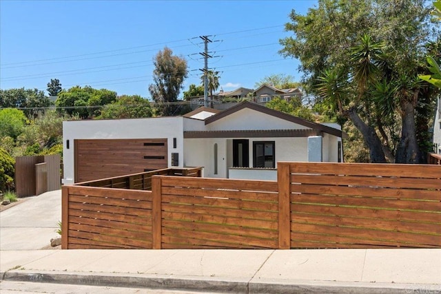 2464 Haller St, San Diego, CA 92104 - view of front of property with a fenced front yard, stucco siding, a garage, and driveway