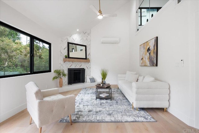 2464 Haller St, San Diego, CA 92104 - living room with ceiling fan, baseboards, wood finished floors, a wall mounted air conditioner, and high vaulted ceiling