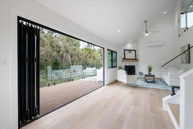 2464 Haller St, San Diego, CA 92104 - living room with a premium fireplace, wood finished floors, an AC wall unit, high vaulted ceiling, and a ceiling fan