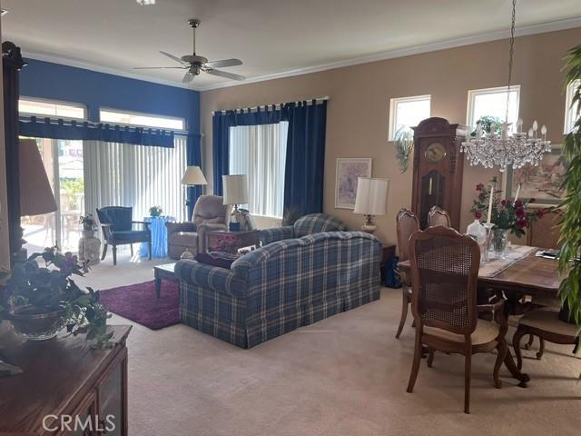 5001 Rolling Hls, Banning, CA 92220 - carpeted living area with crown molding and ceiling fan