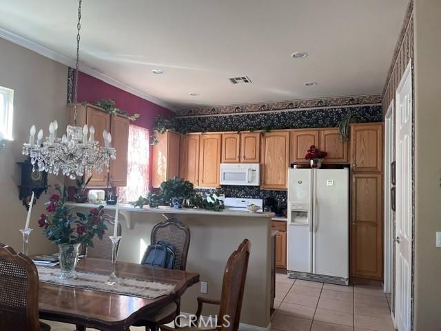 5001 Rolling Hls, Banning, CA 92220 - kitchen with white appliances, light tile patterned floors, brown cabinets, ornamental molding, and a peninsula
