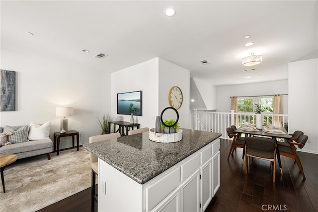 68 Webber Way, Buena Park, CA 90621 - kitchen featuring open floor plan, dark stone counters, white cabinetry, dark wood-type flooring, and a center island