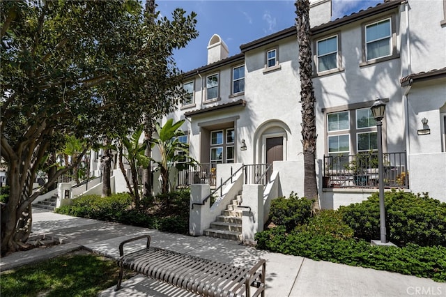 68 Webber Way, Buena Park, CA 90621 - townhome / multi-family property with a chimney, stucco siding, and stairway