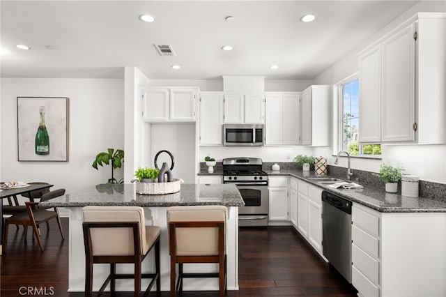 68 Webber Way, Buena Park, CA 90621 - kitchen featuring appliances with stainless steel finishes, a sink, white cabinetry, recessed lighting, and dark wood-style flooring
