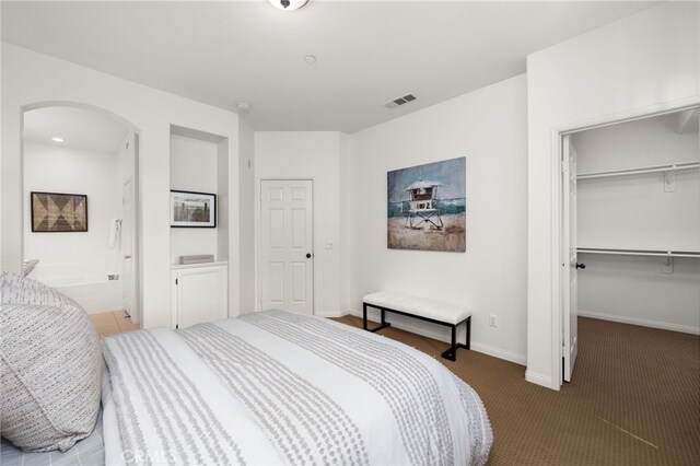 68 Webber Way, Buena Park, CA 90621 - carpeted bedroom with arched walkways, a walk in closet, a closet, ensuite bath, and baseboards
