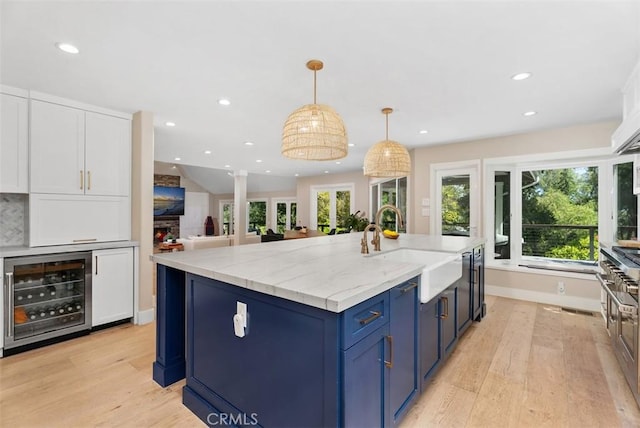 31852 Via Faisan, Coto De Caza, CA 92679 - kitchen featuring wine cooler, a sink, blue cabinets, white cabinets, and recessed lighting