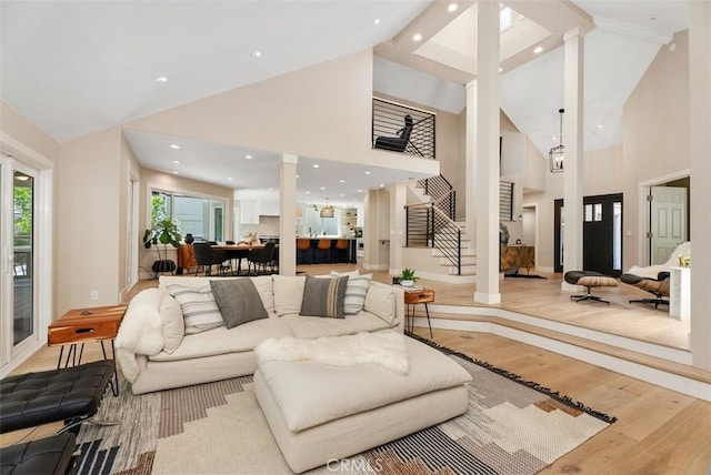 31852 Via Faisan, Coto De Caza, CA 92679 - living area with high vaulted ceiling, wood finished floors, ornate columns, and stairs