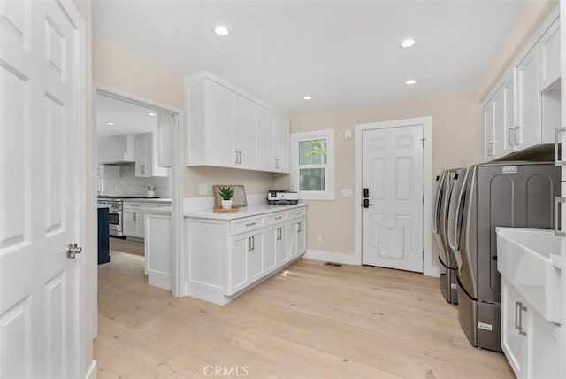 31852 Via Faisan, Coto De Caza, CA 92679 - laundry area with washer and dryer, cabinet space, light wood-type flooring, recessed lighting, and baseboards