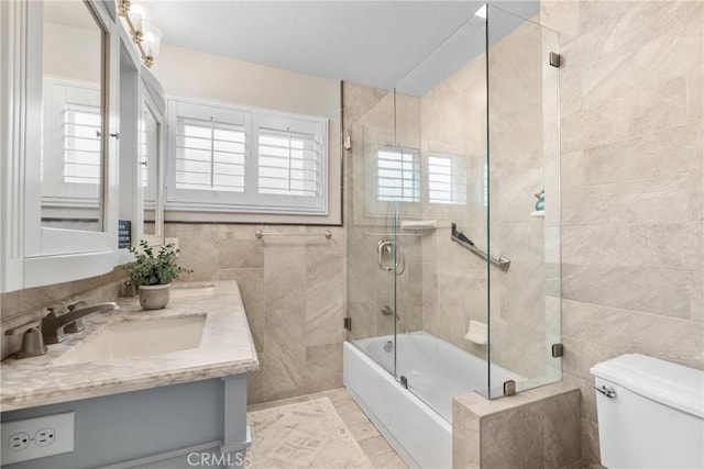 1271 N Tulare Way, Upland, CA 91786 - bathroom featuring tile walls, toilet, bath / shower combo with glass door, and vanity