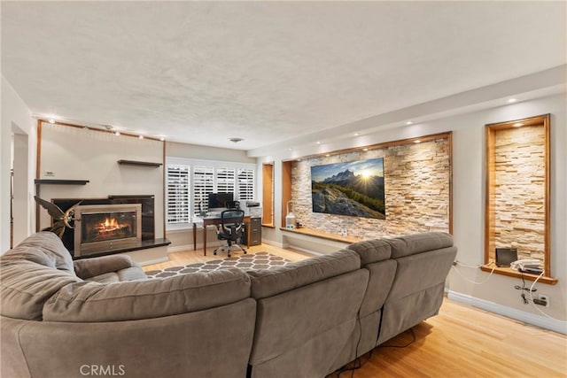 1271 N Tulare Way, Upland, CA 91786 - living area with light wood-style flooring, a glass covered fireplace, baseboards, an office area, and recessed lighting