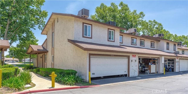 2142 S Mountain Ave, Ontario, CA 91762 - view of property with stucco siding, central air condition unit, and a garage