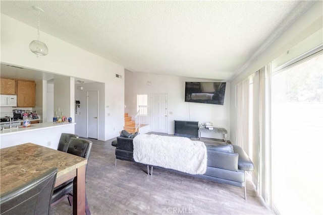 2142 S Mountain Ave, Ontario, CA 91762 - living area with a textured ceiling, wood finished floors, stairway, and lofted ceiling