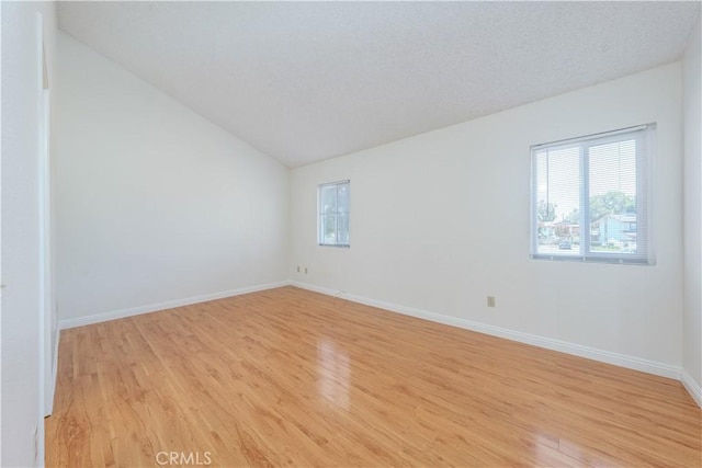 2142 S Mountain Ave, Ontario, CA 91762 - spare room featuring light wood-style floors and lofted ceiling