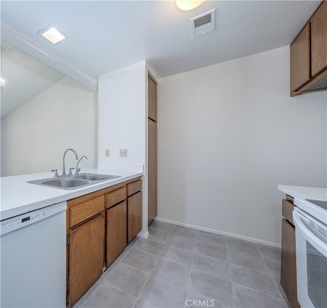 2142 S Mountain Ave, Ontario, CA 91762 - kitchen featuring white dishwasher, light countertops, brown cabinetry, and light tile patterned floors