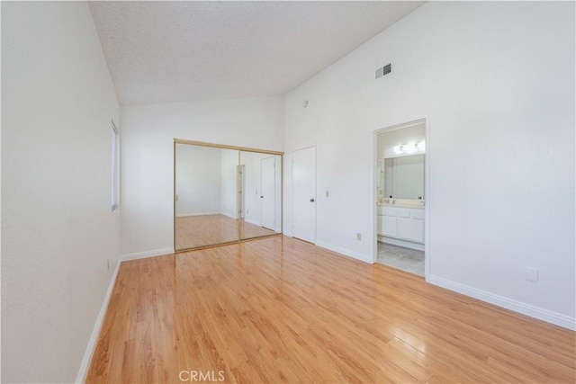 2142 S Mountain Ave, Ontario, CA 91762 - unfurnished bedroom featuring high vaulted ceiling, light wood-style flooring, and ensuite bath