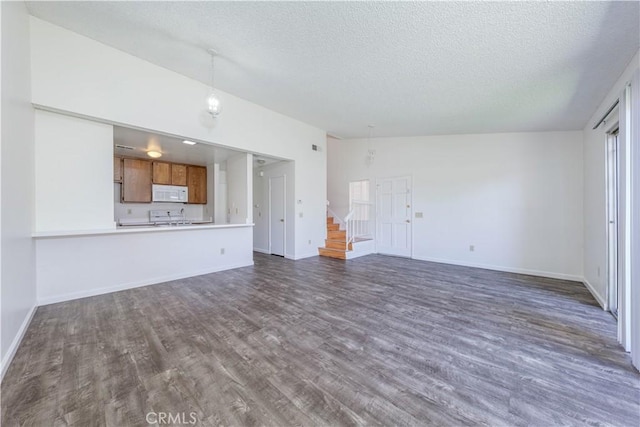 2142 S Mountain Ave, Ontario, CA 91762 - unfurnished living room with a textured ceiling, dark wood finished floors, and stairway