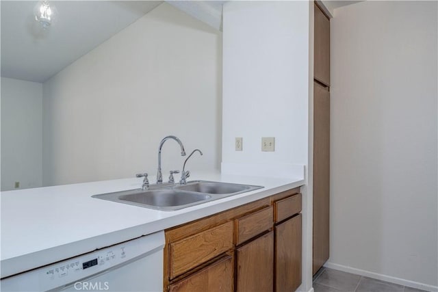 2142 S Mountain Ave, Ontario, CA 91762 - kitchen with white dishwasher, light countertops, light tile patterned floors, and brown cabinets