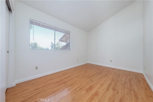 2142 S Mountain Ave, Ontario, CA 91762 - spare room with light wood-style flooring and vaulted ceiling