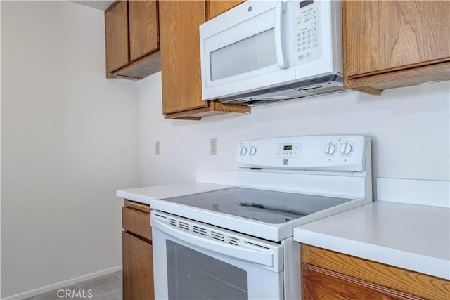 2142 S Mountain Ave, Ontario, CA 91762 - kitchen with white appliances, light countertops, and brown cabinets