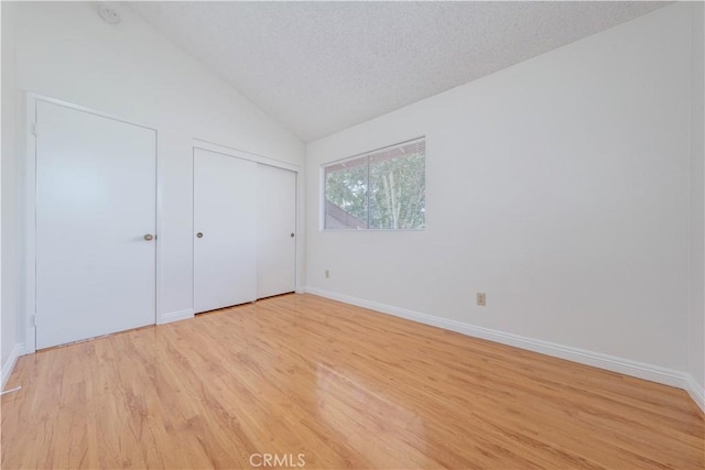 2142 S Mountain Ave, Ontario, CA 91762 - unfurnished bedroom featuring light wood-style flooring, vaulted ceiling, and a textured ceiling