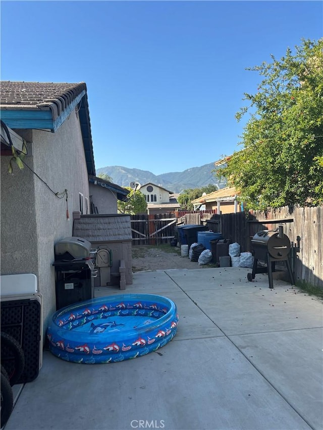 2869 Rosarita St, San Bernardino, CA 92407 - fenced backyard with a mountain view, a patio area, and grilling area