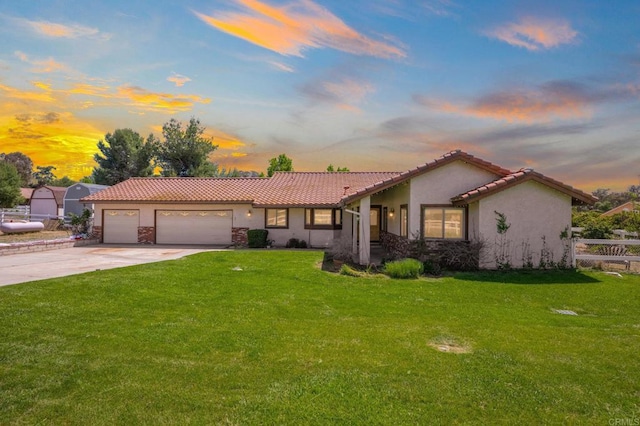 17985 Copper Queen Ln, Perris, CA 92570 - mediterranean / spanish-style house with stucco siding, a tiled roof, driveway, and a front yard