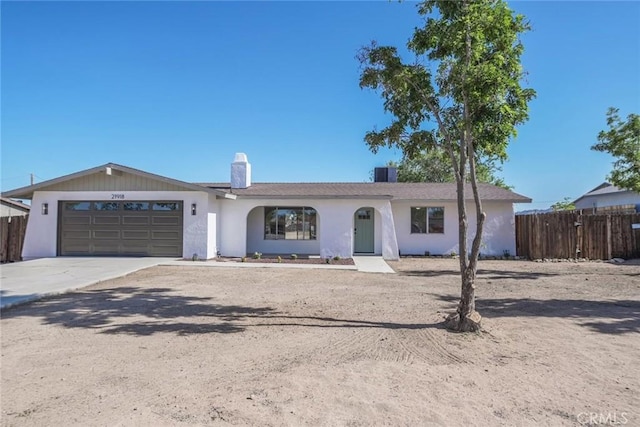 21918 Mohican Ave, Apple Valley, CA 92307 - ranch-style house with a chimney, a garage, driveway, and stucco siding