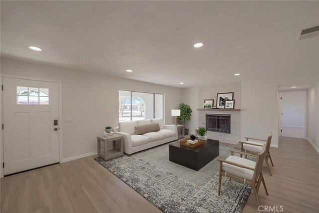 21918 Mohican Ave, Apple Valley, CA 92307 - living area with light wood finished floors, recessed lighting, and a tile fireplace