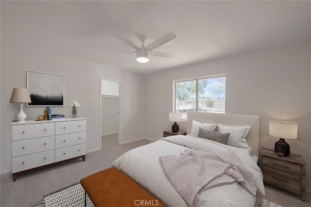 21918 Mohican Ave, Apple Valley, CA 92307 - bedroom featuring light carpet, a walk in closet, a ceiling fan, and a closet