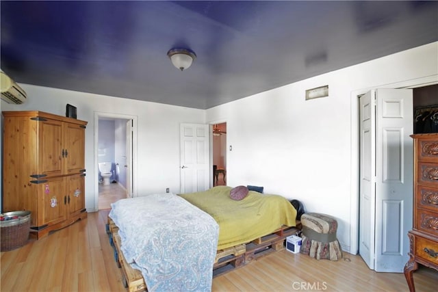 5408 Whitewood Ave, Lakewood, CA 90712 - bedroom with light wood-style floors, a wall unit AC, and connected bathroom