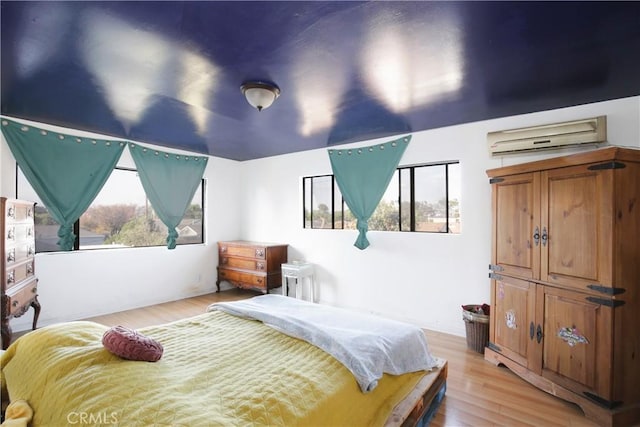 5408 Whitewood Ave, Lakewood, CA 90712 - bedroom featuring a wall mounted AC and light wood-type flooring