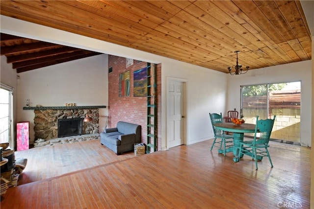 5408 Whitewood Ave, Lakewood, CA 90712 - dining space with a chandelier, hardwood / wood-style floors, a stone fireplace, vaulted ceiling, and wooden ceiling
