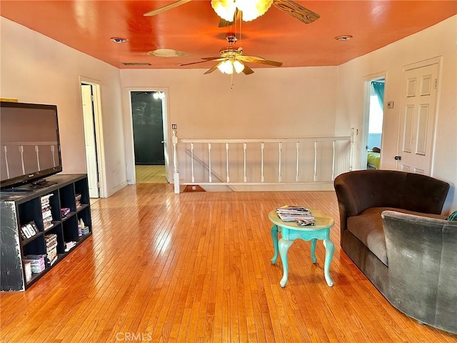 5408 Whitewood Ave, Lakewood, CA 90712 - living area with an upstairs landing, wood-type flooring, ceiling fan, and baseboards