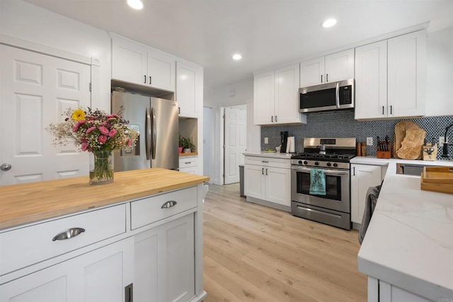 425961 Maryland St, San Diego, CA 92103 - kitchen featuring stainless steel appliances, a sink, tasteful backsplash, white cabinets, and recessed lighting