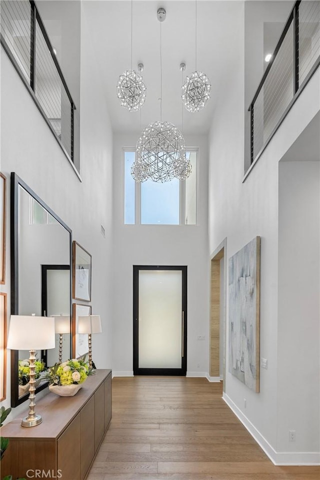 59 Dorado, Irvine, CA 92618 - entrance foyer with a high ceiling, a chandelier, light wood-style floors, and baseboards