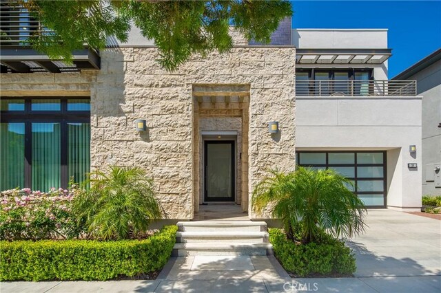 59 Dorado, Irvine, CA 92618 - view of front of house with driveway, stone siding, and a balcony