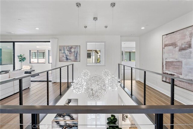 59 Dorado, Irvine, CA 92618 - hall featuring wood finished floors, an upstairs landing, a chandelier, and recessed lighting