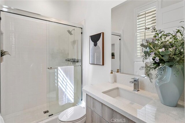 59 Dorado, Irvine, CA 92618 - bathroom featuring toilet, vanity, a shower stall, and healthy amount of natural light