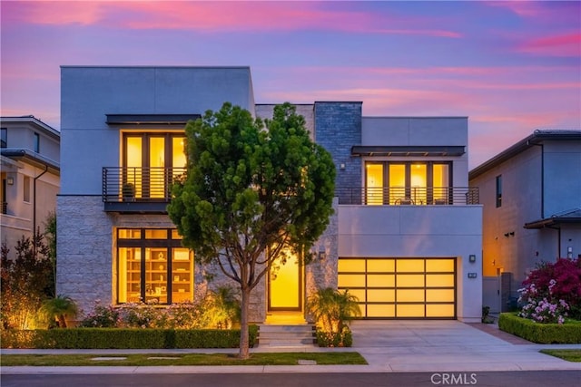 59 Dorado, Irvine, CA 92618 - contemporary home with a balcony, concrete driveway, an attached garage, stucco siding, and stone siding