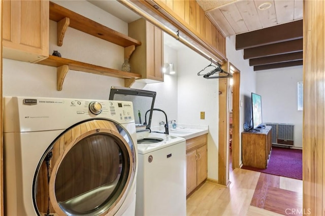 24514 Albrun Dr, Crestline, CA 92325 - laundry room with cabinet space, light wood-type flooring, and washing machine and dryer
