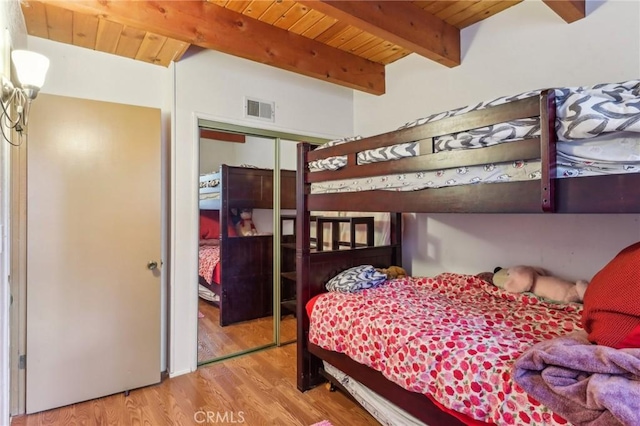 24514 Albrun Dr, Crestline, CA 92325 - bedroom with wood finished floors, wood ceiling with exposed beams, and a closet