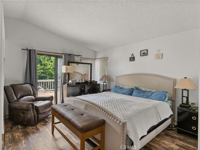 bedroom featuring wood finished floors, lofted ceiling, access to exterior, and a textured ceiling