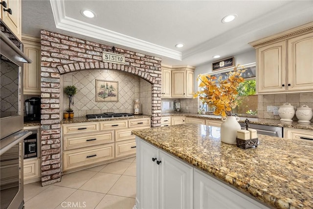 5034 Vista Montana, Yorba Linda, CA 92886 - kitchen featuring cream cabinetry, appliances with stainless steel finishes, tasteful backsplash, light stone countertops, and recessed lighting
