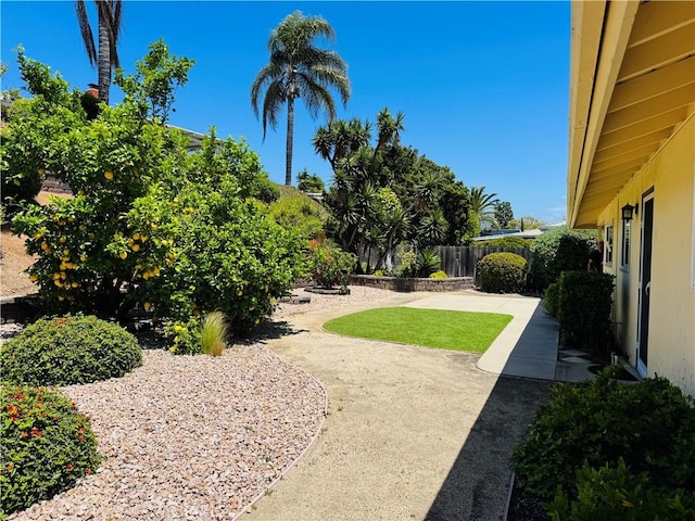 view of yard featuring fence and a patio